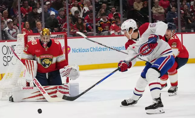 Florida Panthers goaltender Daniil Tarasov (40) defends a shot by Montréal Canadiens center Oliver Kapanen, right, during the first period of an NHL hockey game, Tuesday, Dec. 30, 2025, in Sunrise, Fla. (AP Photo/Lynne Sladky)