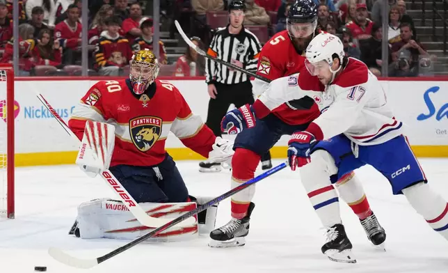 Florida Panthers goaltender Daniil Tarasov (40) and defenseman Aaron Ekblad (5) defend against Montréal Canadiens right wing Josh Anderson (17) during the first period of an NHL hockey game, Tuesday, Dec. 30, 2025, in Sunrise, Fla. (AP Photo/Lynne Sladky)