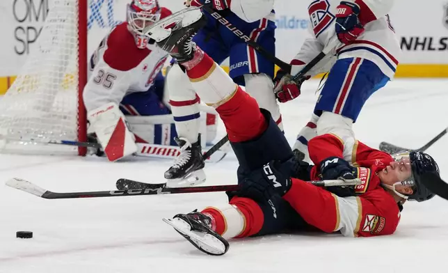 Florida Panthers center Anton Lundell falls to the ice during the second period of an NHL hockey game against the Montréal Canadiens, Tuesday, Dec. 30, 2025, in Sunrise, Fla. (AP Photo/Lynne Sladky)