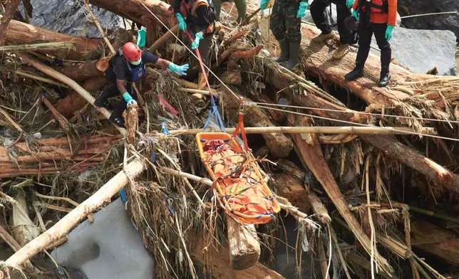 Rescuers use ropes to evacuate the body of a flood victim in Tanah Datar, West Sumatra, Indonesia, Monday, Dec. 1, 2025. (AP Photo/Nazar Chaniago)