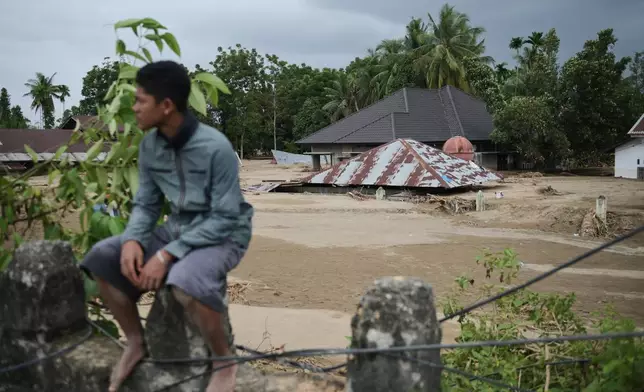 A house is seen buried in the mud at a village affected by flash flood in Pidie Jaya, Aceh province, Indonesia, Tuesday, Dec. 2, 2025. (AP Photo/Reza Saifullah)