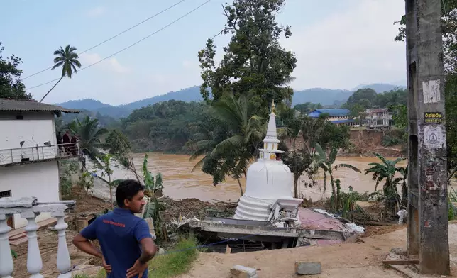 A man looks at the damage caused by the floods at Gampola, Sri Lanka, Monday, Dec.1, 2025. (AP Photo/Eranga Jayawardena)