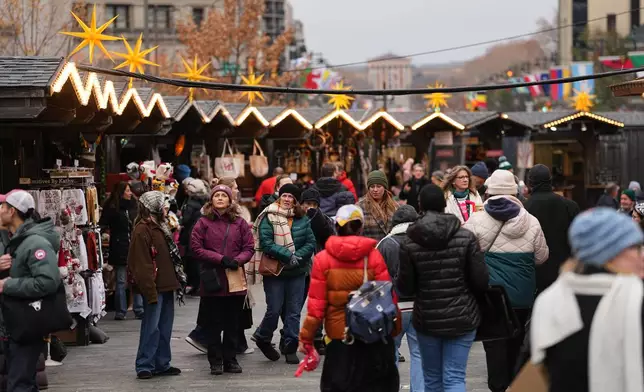 FILE - People shop at the Christmas Village in Philadelphia, in Philadelphia, Wednesday, Dec. 10, 2025. (AP Photo/Matt Rourke, File)