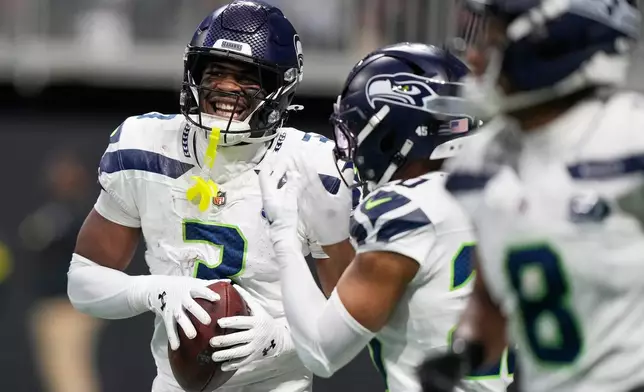 Seattle Seahawks safety Nick Emmanwori (3) celebrates his interception against the Atlanta Falcons during the second half of an NFL football game, Sunday, Dec. 7, 2025, in Atlanta. (AP Photo/Brynn Anderson)