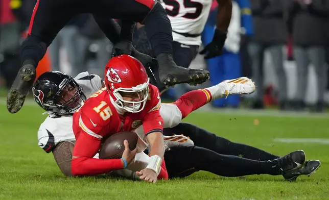 Kansas City Chiefs quarterback Patrick Mahomes (15) is sacked by Houston Texans defensive tackle Tommy Togiai during the first half of an NFL football game Sunday, Dec. 7, 2025, in Kansas City, Mo. (AP Photo/Ed Zurga)