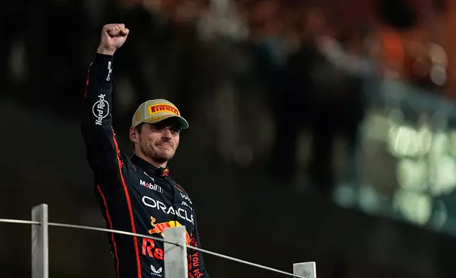 Red Bull driver Max Verstappen of the Netherlands celebrates on the podium after winning the Formula One Abu Dhabi Grand Prix at the Yas Marina Circuit in Abu Dhabi, UAE, Sunday, Dec. 7, 2025. (AP Photo/Fatima Shbair)