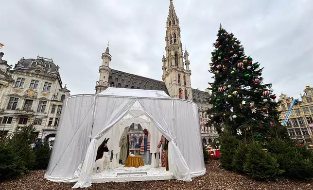 A Nativity scene containing characters with cloth faces, by Belgian artist Victoria-Maria Geyer, is displayed in a white tent in Brussels, Monday, Dec. 1, 2025. (AP Photo/Sylvain Plazy)