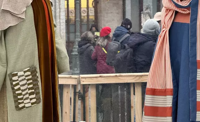 A Nativity scene containing characters with cloth faces, by Belgian artist Victoria-Maria Geyer, is displayed in a white tent in Brussels, Monday, Dec. 1, 2025. (AP Photo/Sylvain Plazy)
