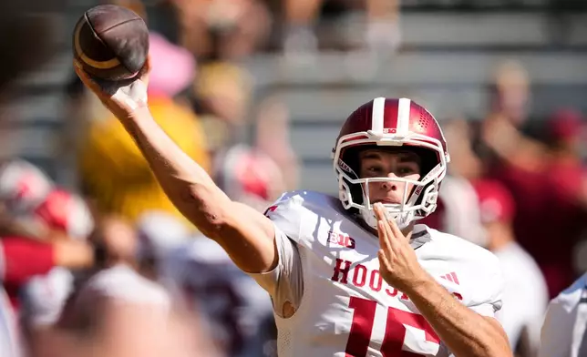 FILE - Indiana quarterback Fernando Mendoza warms up before an NCAA college football game against Iowa, Saturday, Sept. 27, 2025, in Iowa City, Iowa. (AP Photo/Charlie Neibergall, File)