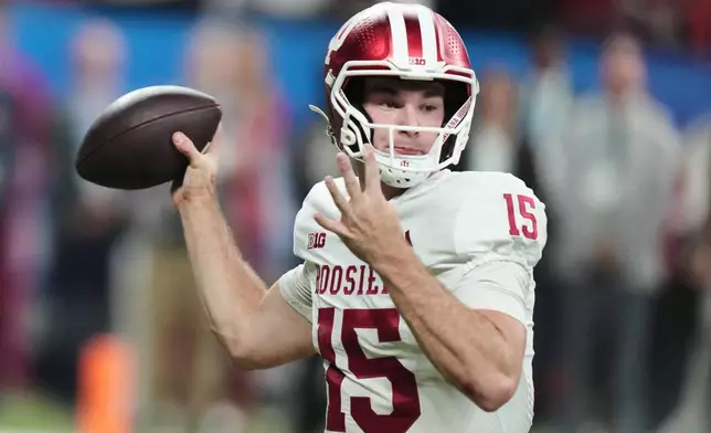 FILE - Indiana's Fernando Mendoza throws during the first half of the Big Ten championship NCAA college football game against Ohio State in Indianapolis, Saturday, Dec. 6, 2025. (AP Photo/AJ Mast, File)
