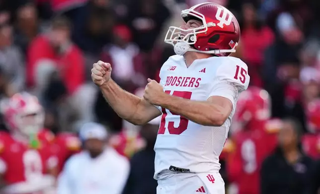 FILE - Indiana quarterback Fernando Mendoza (15) celebrates after throwing a touchdown pass to wide receiver Omar Cooper Jr. during the first half of an NCAA college football game against Maryland, Saturday, Nov. 1, 2025, in College Park, Md. (AP Photo/Stephanie Scarbrough, File)