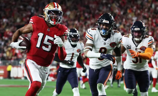 San Francisco 49ers wide receiver Jauan Jennings (15) runs toward the end zone to score against the Chicago Bears during the second half of an NFL football game in Santa Clara, Calif., Sunday, Dec. 28, 2025. (AP Photo/Jed Jacobsohn)
