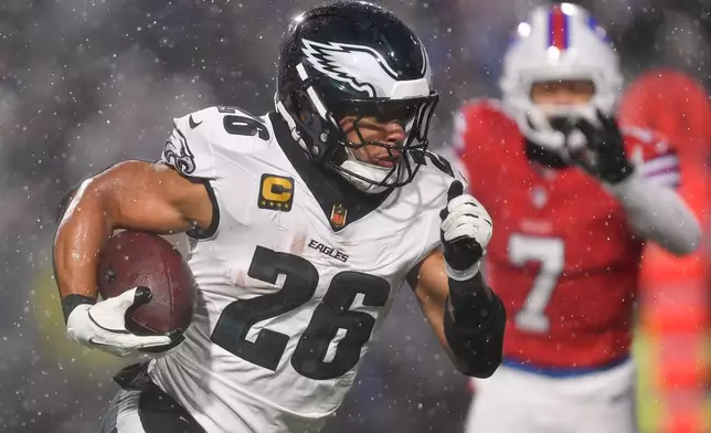 Philadelphia Eagles' Saquon Barkley runs during the first half of an NFL football game against the Buffalo Bills, Sunday, Dec. 28, 2025, in Buffalo, N.Y. (AP Photo/Adrian Kraus)