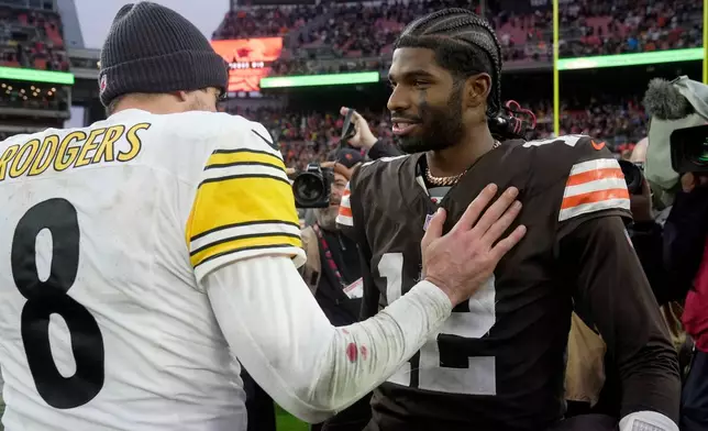 Cleveland Browns quarterback Shedeur Sanders (12) talks with Pittsburgh Steelers quarterback Aaron Rodgers (8) after an NFL football game, Sunday, Dec. 28, 2025, in Cleveland. (AP Photo/Sue Ogrocki)