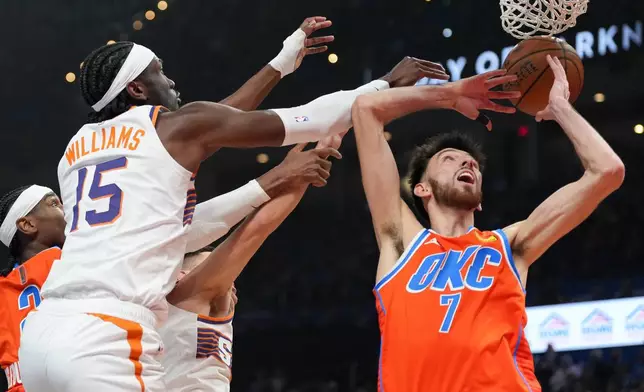 Phoenix Suns center Mark Williams (15) tries to get to a rebound before Oklahoma City Thunder center Chet Holmgren (7) during the first half of an NBA Cup basketball game, Wednesday, Dec. 10, 2025, in Oklahoma City. (AP Photo/Kyle Phillips)