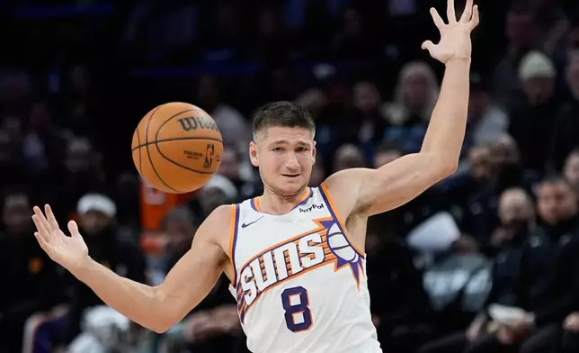 Phoenix Suns guard Grayson Allen (8) loses control of the ball during the second half of an NBA basketball game against the Minnesota Timberwolves, Monday, Dec. 8, 2025, in Minneapolis. (AP Photo/Abbie Parr)