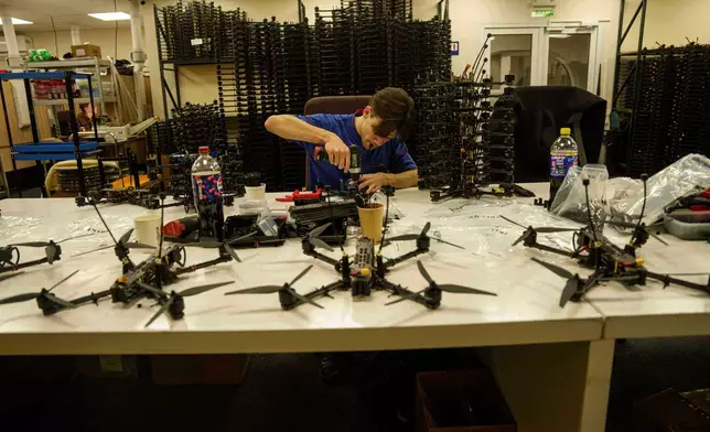 An engineer assembles FPV drone of "General Cherry" company at the workshop in Ukraine, on Dec. 4, 2025. (AP Photo/Evgeniy Maloletka)