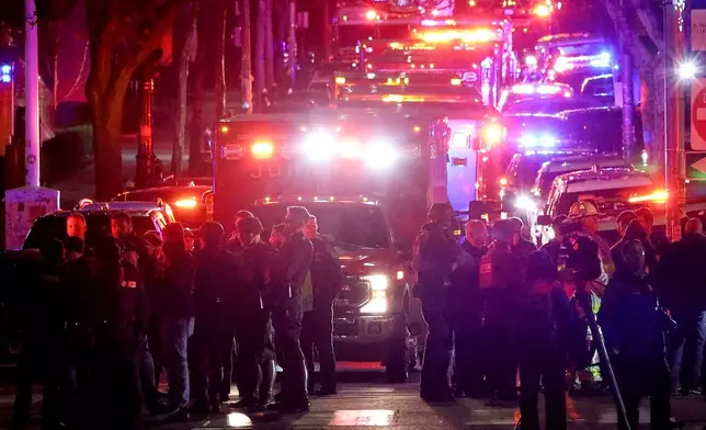 Emergency personnel gather on Waterman Street at Brown University in Providence, R.I., on Saturday, Dec. 13, 2025, during the investigation of a shooting. (AP Photo/Mark Stockwell)