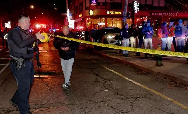 Emergency personnel gather on Waterman Street at Brown University in Providence, R.I., on Saturday, Dec. 13, 2025, during the investigation of a shooting. (AP Photo/Mark Stockwell)