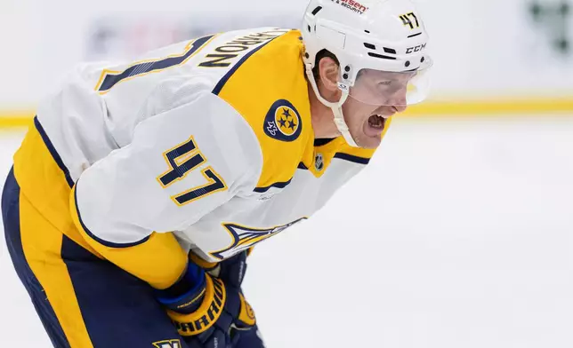 Nashville Predators' Michael McCarron (47) skates back to the bench in pain after a slash in the second period of an NHL hockey game against the Minnesota Wild, Tuesday, Dec. 23, 2025, in St. Paul, Minn. (Carlos Gonzalez/Star Tribune via AP)