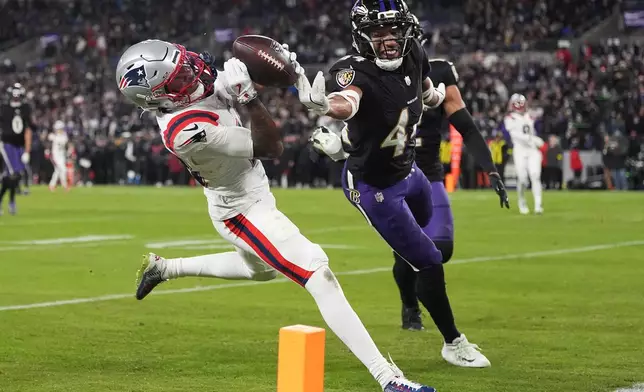 New England Patriots wide receiver Kyle Williams, left, catches a touchdown against Baltimore Ravens cornerback Marlon Humphrey (44) during the second half of an NFL football game, Sunday, Dec. 21, 2025, in Baltimore. (AP Photo/Stephanie Scarbrough)
