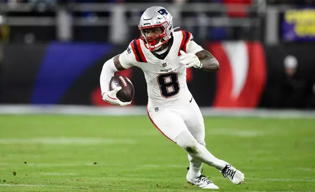 New England Patriots wide receiver Stefon Diggs (8) runs against the Baltimore Ravens during the second half of an NFL football game, Sunday, Dec. 21, 2025, in Baltimore. (AP Photo/Nick Wass)