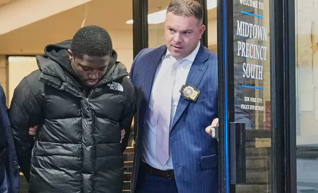 Frederick Green, 20, of The Bronx borough of New York, charged with attempted murder in the shooting of New York Jets' player Kris Boyd, is escorted from the Midtown South Police Precinct, in New York, Tuesday, Dec. 9, 2025. (AP Photo/Richard Drew)