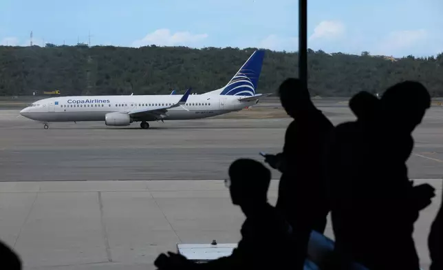 A COPA Airlines plane taxis at Simon Bolivar International Airport in Maiquetia, Venezuela, Monday, Dec. 1, 2025, days after the government revoked operating rights for international airlines that suspended flights following a warning from the U.S. Federal Aviation Administration.(AP Photo/Cristian Hernandez)