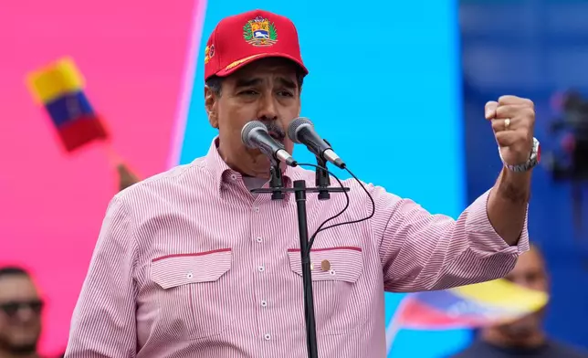 Venezuelan President Nicolas Maduro addresses supporters during a swearing-in event for government-organized community committees at the presidential palace in Caracas, Venezuela, Monday, Dec. 1, 2025. (AP Photo/Ariana Cubillos)