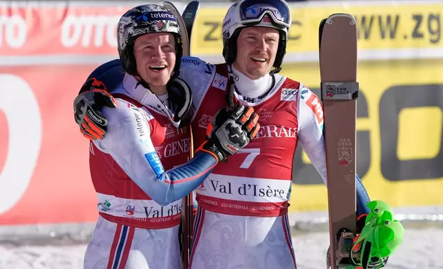Norway's Timon Haugan, left, winner of an alpine ski, men's World Cup slalom event, celebrates with second placed fellow-countryman Henrik Kristoffersen, in Val d'Isere, France, Sunday Dec. 14, 2025. (AP Photo/Giovanni Auletta)