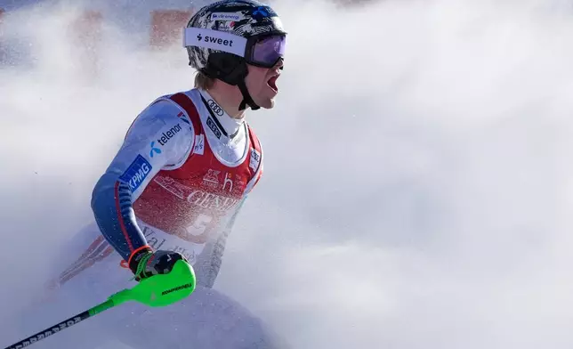 Norway's Timon Haugan celebrates winning an alpine ski, men's World Cup slalom event, in Val d'Isere, France, Sunday Dec. 14, 2025. (AP Photo/Giovanni Auletta)