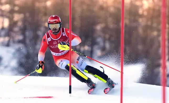 Switzerland's Loic Meillard speeds down the course during an alpine ski, men's World Cup slalom event, in Val d'Isere, France, Sunday Dec. 14, 2025. (AP Photo/Giovanni Auletta)