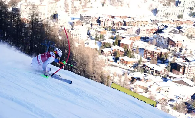 Norway's Henrik Kristoffersen speeds down the course during an alpine ski, men's World Cup slalom event, in Val d'Isere, France, Sunday Dec. 14, 2025. (AP Photo/Pier Marco Tacca)