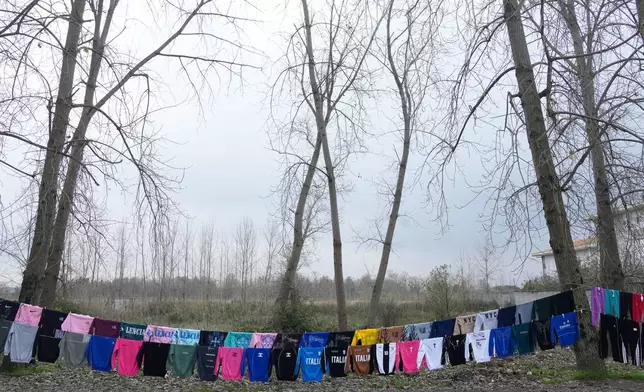 Clothes hang for sale on the roadside on the outskirts of the port city of Bandar Anzali, along the southern coast of the Caspian Sea in Iran, Tuesday, Dec. 23, 2025. (AP Photo/Vahid Salemi)
