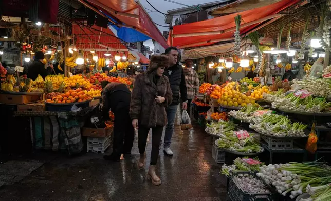 People shop in the old main bazaar of the northern city of Rasht, Iran, on Friday, Dec. 26, 2025. (AP Photo/Vahid Salemi)