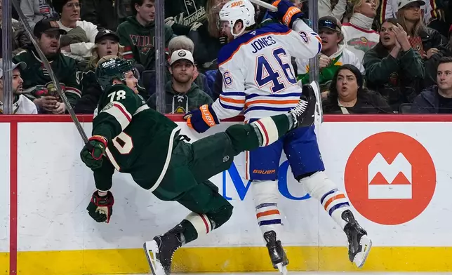 Minnesota Wild center Nico Sturm (78) and Edmonton Oilers left wing Max Jones (46) collide during the second period of an NHL hockey game, Saturday, Dec. 20, 2025, in St. Paul, Minn. (AP Photo/Abbie Parr)