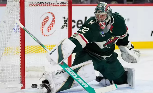 Minnesota Wild goaltender Filip Gustavsson (32) blocks a shot during the second period of an NHL hockey game against the Edmonton Oilers, Saturday, Dec. 20, 2025, in St. Paul, Minn. (AP Photo/Abbie Parr)