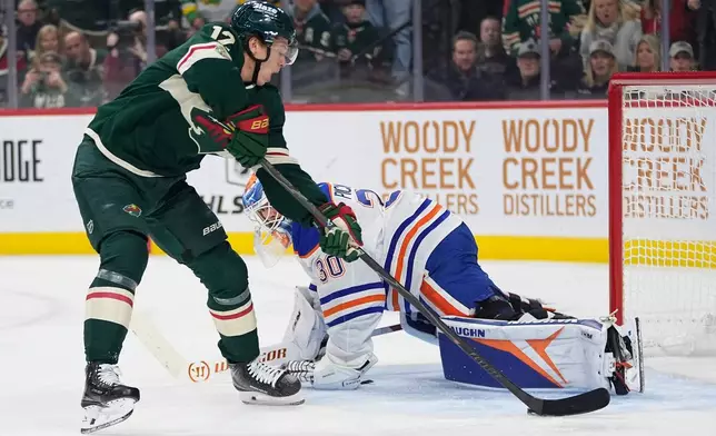 Minnesota Wild left wing Matt Boldy (12) shoots and scores a goal past Edmonton Oilers goaltender Calvin Pickard (30) during the first period of an NHL hockey game, Saturday, Dec. 20, 2025, in St. Paul, Minn. (AP Photo/Abbie Parr)