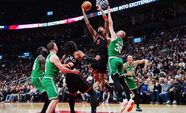 Toronto Raptors' Brandon Ingram (3) goes up to shoot over Boston Celtics' Sam Hauser (30) during first-half NBA basketball game action in Toronto, Saturday, Dec. 20, 2025. (Frank Gunn/The Canadian Press via AP)