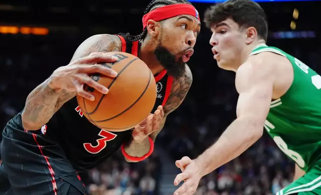 Toronto Raptors' Brandon Ingram (3) drives against Boston Celtics' Hugo Gonzalez, right, during first-half NBA basketball game action in Toronto, Saturday, Dec. 20, 2025. (Frank Gunn/The Canadian Press via AP)