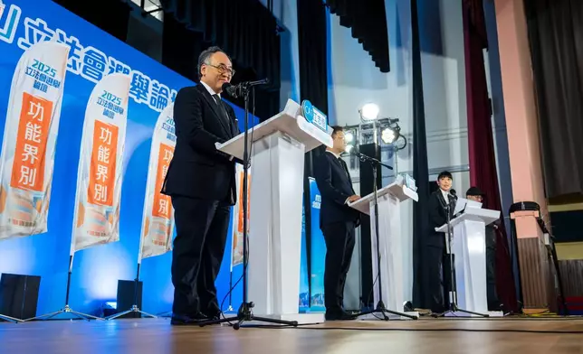Kong Chi Hang, left, and Jonathan Leung, candidates of the Legislative Council Catering functional constituency election attend a forum in Hong Kong on Wednesday, Dec. 3, 2025. (AP Photo/Chan Long Hei)