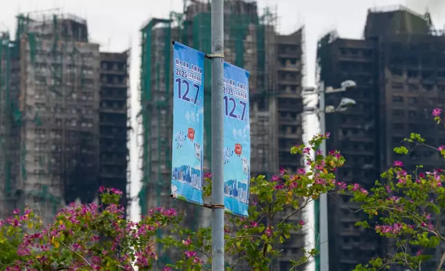 Banners promoting the Hong Kong Legislative Council General Election hang near the site of the fire at Wang Fuk Court in the Tai Po district of Hong Kong on Wednesday, Dec. 3, 2025. (AP Photo/Chan Long Hei)
