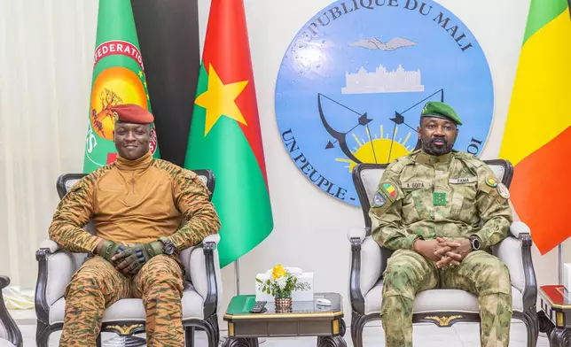 Captain Ibrahim Traoré of Burkina Faso, left, sits with General Assimi Goïta of Mali, during the second summit on security and development in Bamako, Mali, Tuesday, Dec. 23, 2025. (Mali Government Information Center via AP)