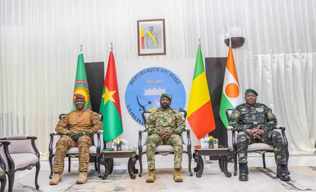 Captain Ibrahim Traoré of Burkina Faso, left, General Assimi Goïta of Mali, center, and General Abdourahamane Tchiani of Niger attend the second summit on security and development in Bamako, Mali, Tuesday, Dec. 23, 2025. (Mali Government Information Center via AP)