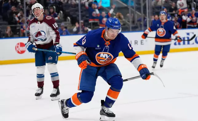 New York Islanders' Mathew Barzal celebrates his goal during the second period of an NHL hockey game against the Colorado Avalanche, Thursday, Dec. 4, 2025, in Elmont, N.Y. (AP Photo/Seth Wenig)