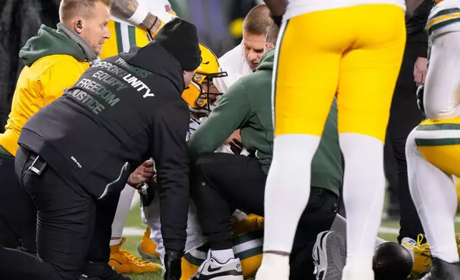 Green Bay Packers' Jordan Love is attended to after being hurt during the first half of an NFL football game against the Chicago Bears Saturday, Dec. 20, 2025, in Chicago. (AP Photo/Nam Huh)