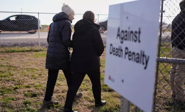 People enter the area reserved for anti-death penalty demonstators outside Riverbend Maximum Security Institution before the execution of Harold Wayne Nichols, Thursday, Dec. 11, 2025, in Nashville, Tenn. (AP Photo/George Walker IV)