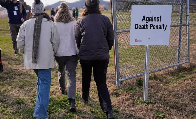 People enter the area reserved for anti-death penalty demonstators outside Riverbend Maximum Security Institution before the execution of Harold Wayne Nichols, Thursday, Dec. 11, 2025, in Nashville, Tenn. (AP Photo/George Walker IV)