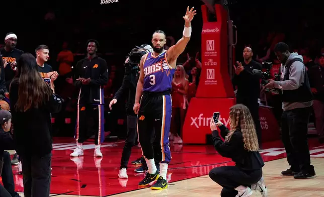 Phoenix Suns forward Dillon Brooks (3) waves after a tribute video played before an NBA basketball game against the Houston Rockets in Houston, Friday, Dec. 5, 2025. (AP Photo/Ashley Landis)
