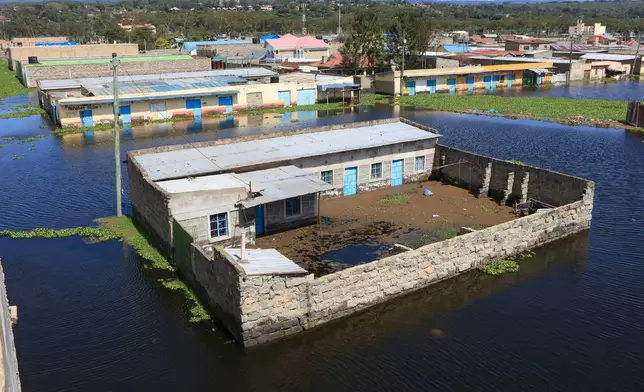 Residential buildings are submerged after Lake Naivasha swelled and flooded homes, displacing hundreds in Kihoto Village, in Naivasha, Kenya's Rift Valley region, Tuesday, Nov. 11, 2025. (AP Photo/Andrew Kasuku)